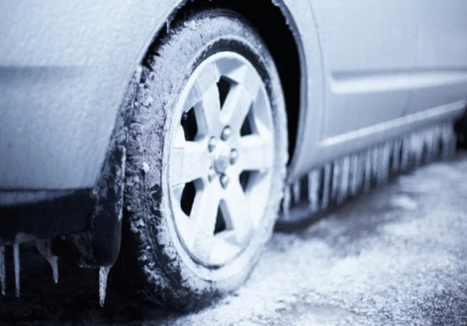 icy car tire on silver car