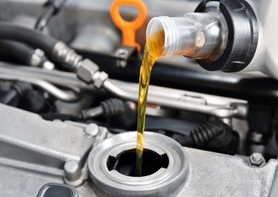 oil being poured into a car engine
